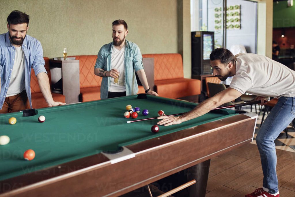 friends playing billiards together 2