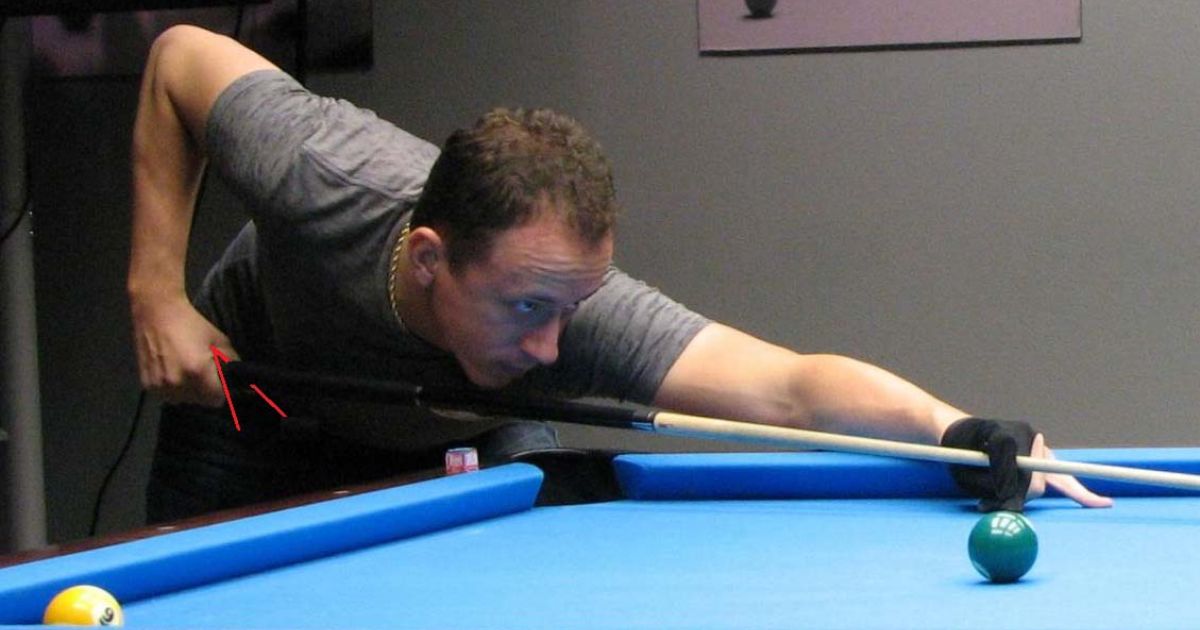 Grip the pool cue close to your waist